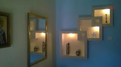 a bathroom with a mirror and some vases on a wall at Family House Pavicevic in Bar