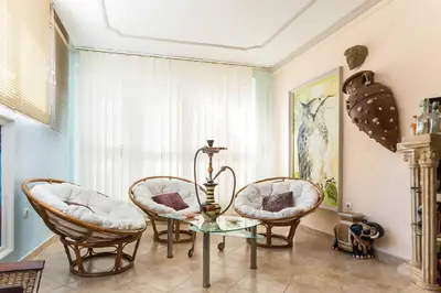 a living room with two chairs and a glass table at Family House Pavicevic in Bar