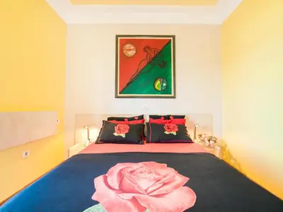 a bedroom with a bed with a pink blanket on it at Villa Royal Dream in Sveti Stefan