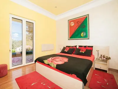 a bedroom with a large bed and a window at Villa Royal Dream in Sveti Stefan