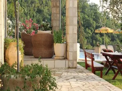 a patio with a table and chairs and plants at Villa Royal Dream in Sveti Stefan