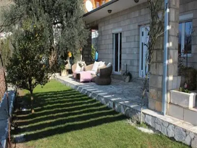 a patio with a pink couch in a yard at Villa Royal Dream in Sveti Stefan
