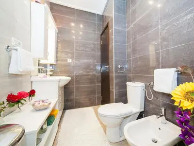 a bathroom with a toilet and a sink at Villa Royal Dream in Sveti Stefan