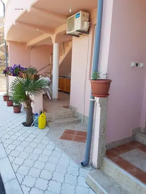 a building with potted plants on the side of it at Family Apartments Pepic in Ulcinj