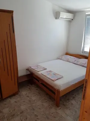 a small bedroom with a bed and a window at Family Apartments Pepic in Ulcinj