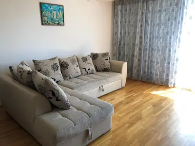 a living room with a couch and wooden floors at Apartment Marina in Bar
