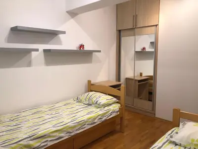 a small bedroom with a bed and a mirror at Apartment Marina in Bar