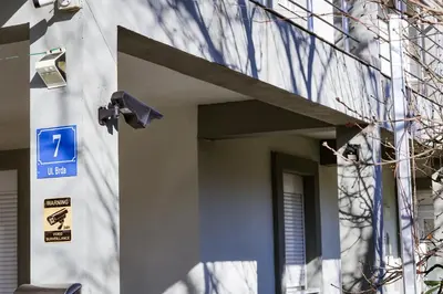 a building with a blue sign on the side of it at Apartman Zorana in Tivat