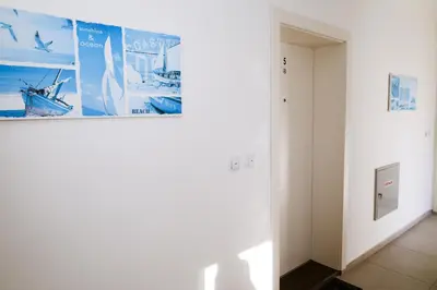 a hallway with white walls and a picture on the wall at Apartman Zorana in Tivat