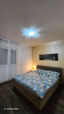 a bedroom with a large bed in a room at Apartments Donja Gorica in Podgorica