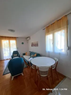 a living room with a table and chairs at Apartments Donja Gorica in Podgorica