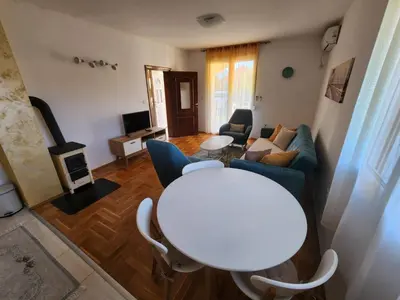 a living room with a white table and a couch at Apartments Donja Gorica in Podgorica