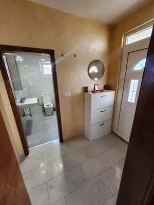a bathroom with a toilet and a sink and a mirror at Apartments Donja Gorica in Podgorica