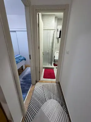 a hallway with a view of a bathroom with a toilet at N&J apartman in Podgorica
