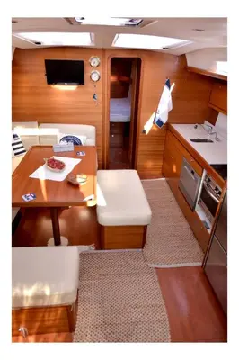 a small room with a table and a kitchen at Yacht Hotel Kotor Marina in Kotor