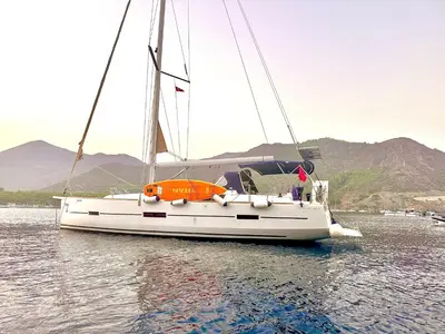 a white sailboat in the water on a lake at Yacht Hotel Kotor Marina in Kotor