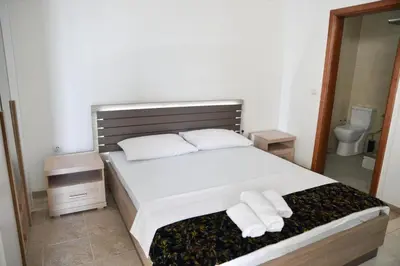 a bedroom with a bed with two towels on it at Casa Bianca 1 in Ulcinj