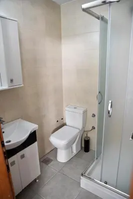 a bathroom with a toilet and a sink and a shower at Casa Bianca 1 in Ulcinj