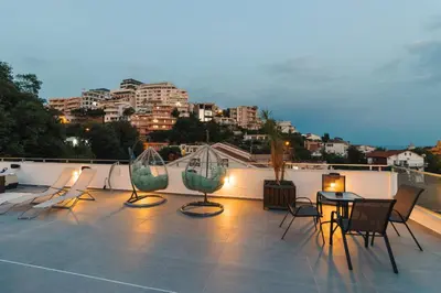 a patio with chairs and a table on a roof at Casa Bianca 1 in Ulcinj