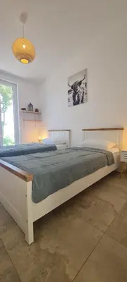 a large bed in a white room with a large bed sidx sidx sidx at Sunrise Lodge in Dapčevići