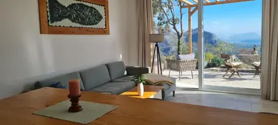 a living room with a couch and a table at Sunrise Lodge in Dapčevići