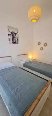 two beds sitting next to each other in a bedroom at Sunrise Lodge in Dapčevići