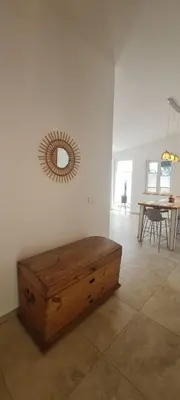 a room with a wooden chest in front of a mirror at Sunrise Lodge in Dapčevići