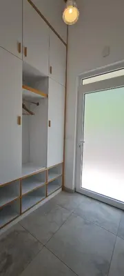 an empty room with a large window and a door at Sunrise Lodge in Dapčevići