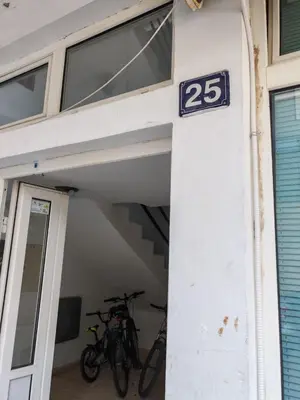 a building with two bikes parked in a garage at Vinogradi in Budva