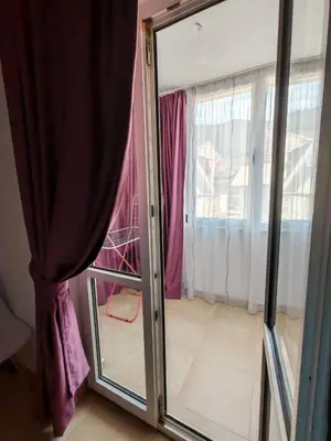 a sliding glass door in a room with a window at Vinogradi in Budva