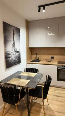 a kitchen with a dining table and a giraffe painting at Luxury Home in Dobra Voda