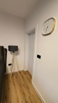 a clock hanging on a wall in a room at Luxury Home in Dobra Voda
