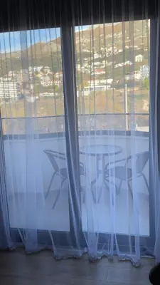 a window with a table and chairs in a room at Luxury Home in Dobra Voda