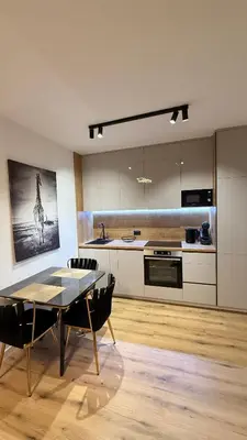a kitchen with a table and a dining room at Luxury Home in Dobra Voda