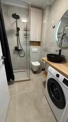 a bathroom with a shower and a washing machine at Luxury Home in Dobra Voda