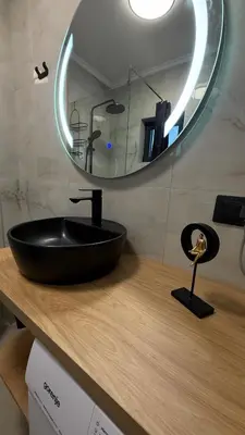 a black sink on a wooden counter with a mirror at Luxury Home in Dobra Voda