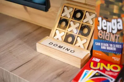 a wooden box of dominoes on a table next to a box of cereal at RAOS Cottage in Ulcinj