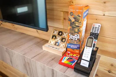 a television and a remote control on a table at RAOS Cottage in Ulcinj
