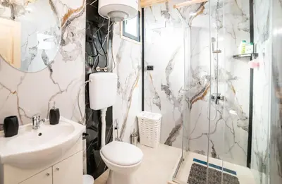 a bathroom with a shower and a toilet and a sink at RAOS Cottage in Ulcinj