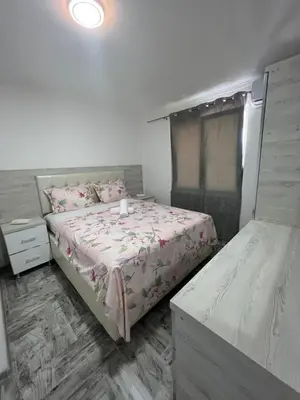 a bedroom with two beds and a window at Apartments DIJAR in Ulcinj