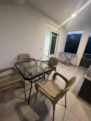 a room with a glass table and chairs on a balcony at Apartments DIJAR in Ulcinj