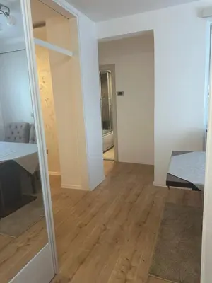 a room with a mirror and a bedroom with a bed at Monte Budva in Budva