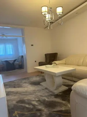 a living room with a white table and a couch at Monte Budva in Budva