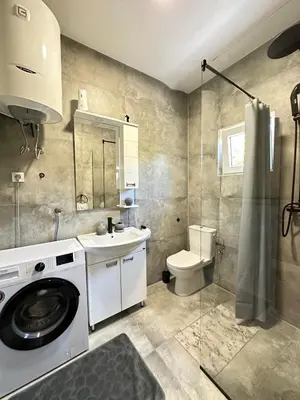 a bathroom with a sink and a washing machine at Apartment Wild Beauty in Kotor