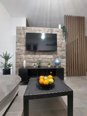a living room with a bowl of fruit on a table at Apartment Wild Beauty in Kotor