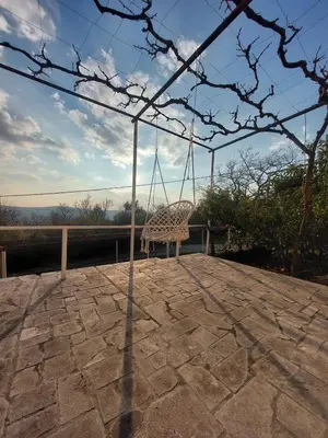 a chair sitting on a patio with a swing at Apartment Wild Beauty in Kotor
