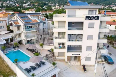 an aerial view of a building with a swimming pool at Vila Kalina Apartments in Sutomore