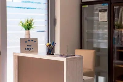 a desk in an office with a sign on it at Vila Kalina Apartments in Sutomore