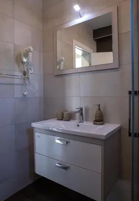 a bathroom with a sink and a mirror at Vila Kalina Apartments in Sutomore