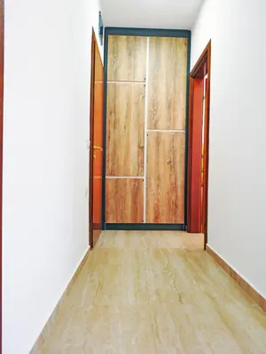 an empty room with a door and a wooden floor at Apartmani Hamburg 1 in Donji Štoj
